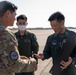 27th Special Operation Wing members receive Japanese Self-Defense Force members at Yokota Air Base, Japan