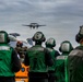 Sailors an E-2D Hawkeye Land Aboard Abraham Lincoln