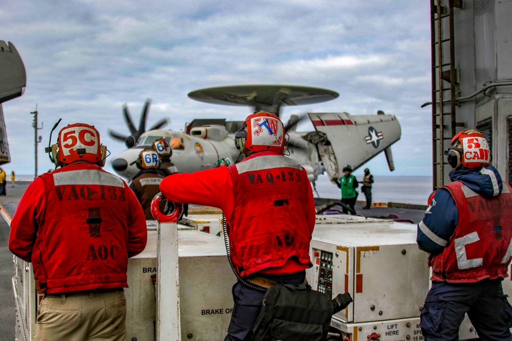 Sailors observe flight operations on the flight deck of Abraham Lincoln