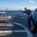 U.S. Navy sailors play corn hole aboard USS Chung-Hoon