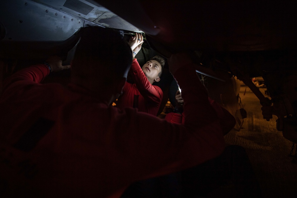 Sailors Perform Maintenance On A Super Hornet