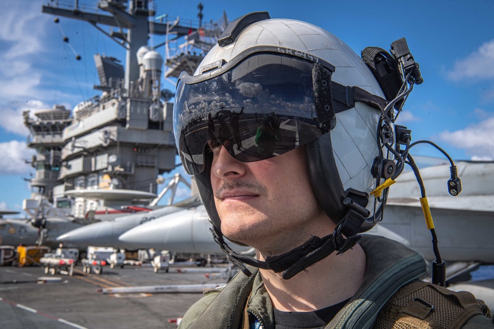 Sailor Observes A Helicopter As It Prepares To Lift Off