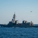 USS Ronald Reagan (CVN 76) steams alongside JS Ikazuchi (DD 107)