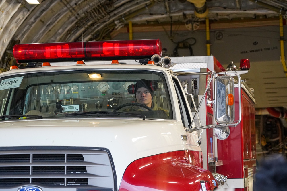 Aerial porter drives firetruck onto C-17