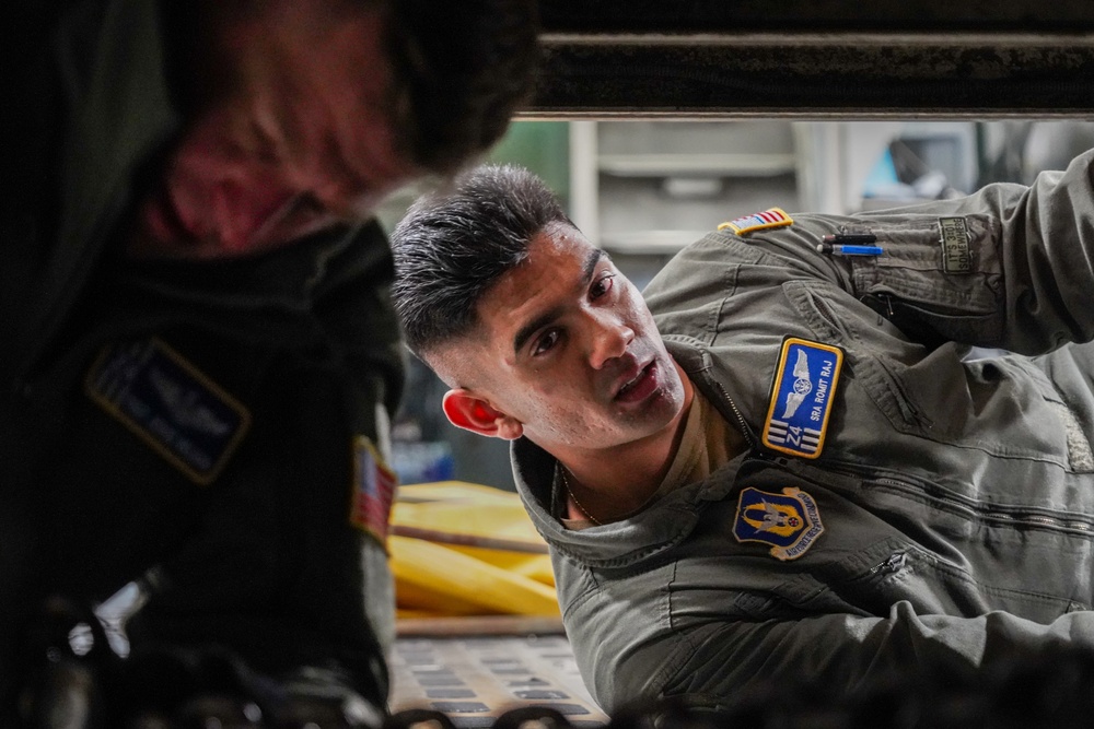 Loadmasters tie down firetruck on C-17