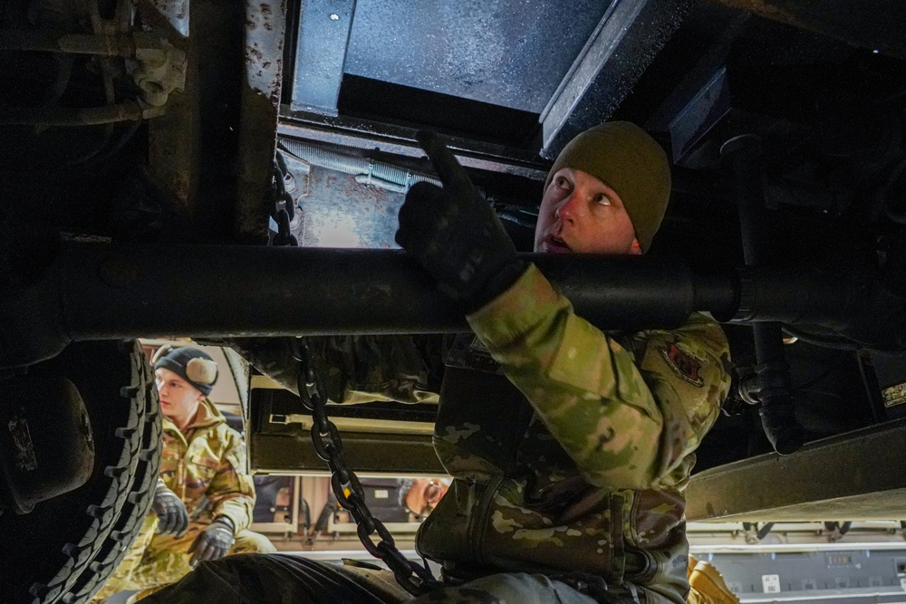 Aerial porter ties down firetruck aboard C-17