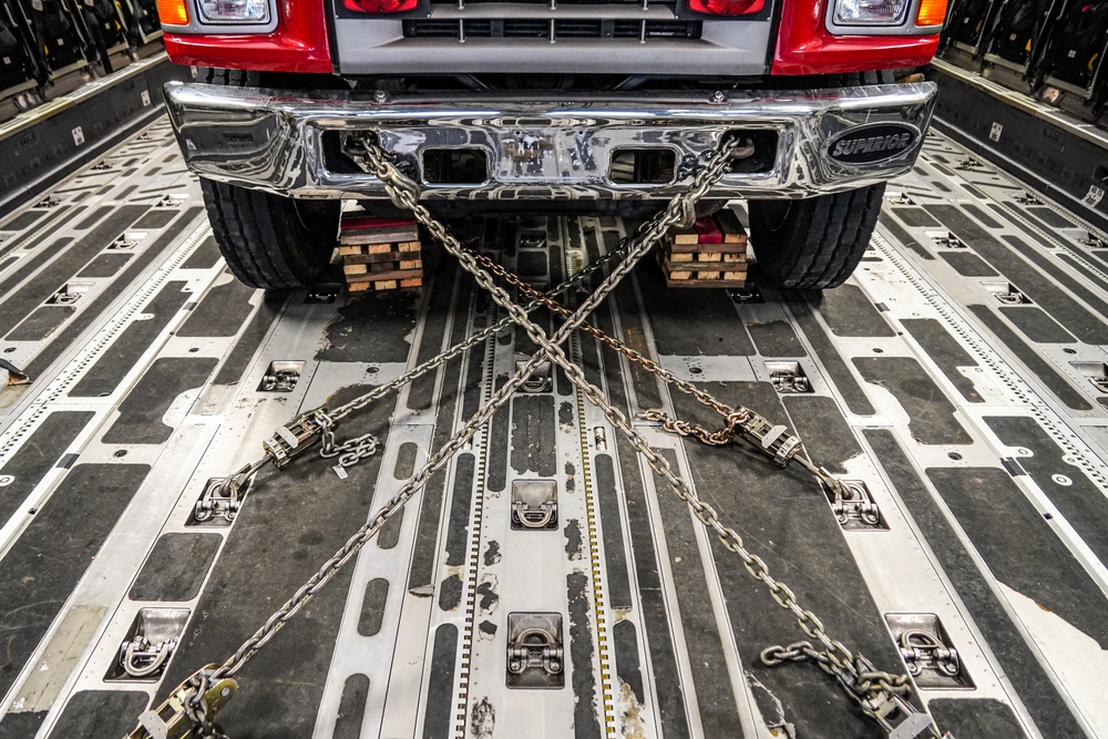 Firetruck chained to C-17 for transport