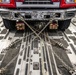 Firetruck chained to C-17 for transport