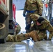 Aerial porters tie down a firetruck to a C-17