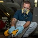 Sailor Uses A Wire Brush On The Deck