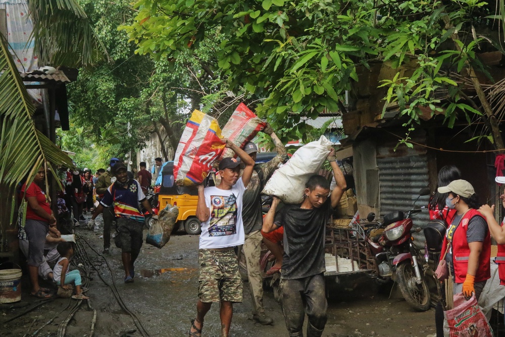 City Officials, Security Force Personnel Clean Up Flooded Zamboanga