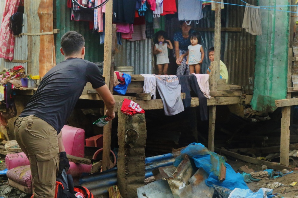 City Officials, Security Force Personnel Clean Up Flooded Zamboanga