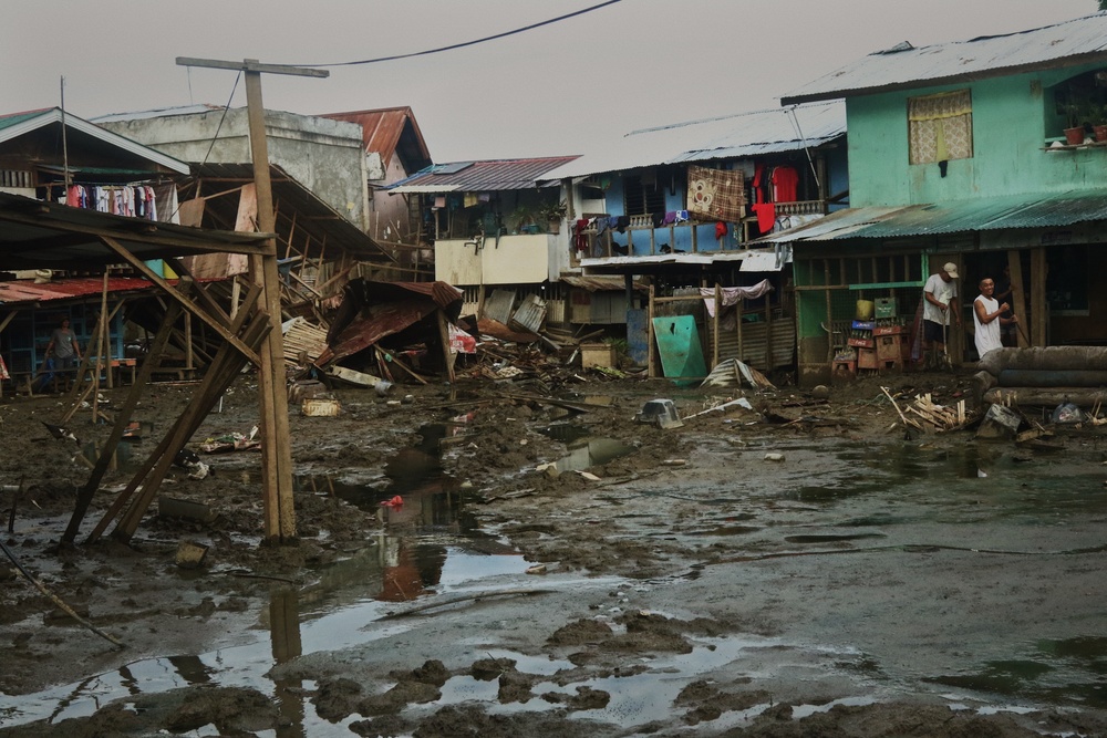 City Officials, Security Force Personnel Clean Up Flooded Zamboanga