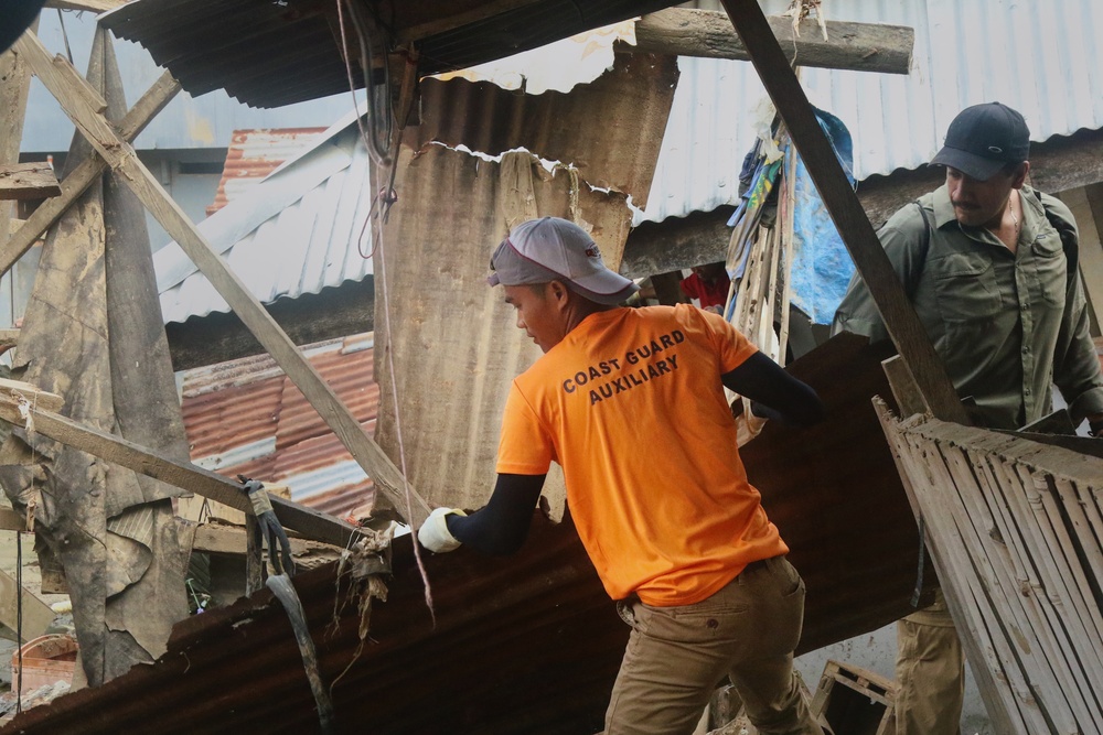 City Officials, Security Force Personnel Clean Up Flooded Zamboanga