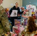 Airman's daughter selects a toy at Spark of Love 2022