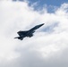 ) A F/A-18E Super Hornet flies over Nimitz-class aircraft carrier USS Carl Vinson