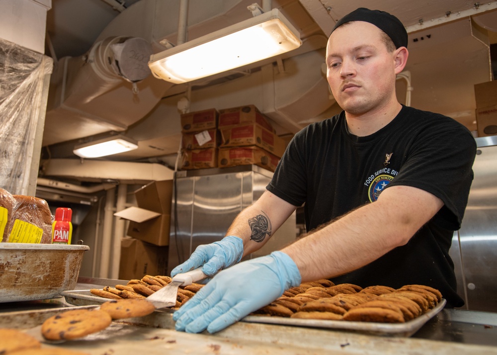 Sailor Moves Cookies To Serving Tray