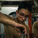 U.S. Navy Engineman cleans piston.