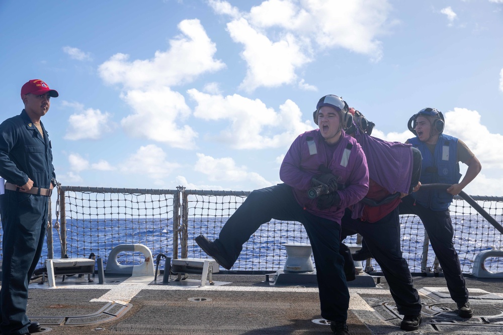 U.S. Navy Sailors participate in flight deck damage control training drills aboard USS Chung-Hoon