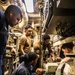 U.S. Navy Sailors replace pump in reverse osmosis water unit.