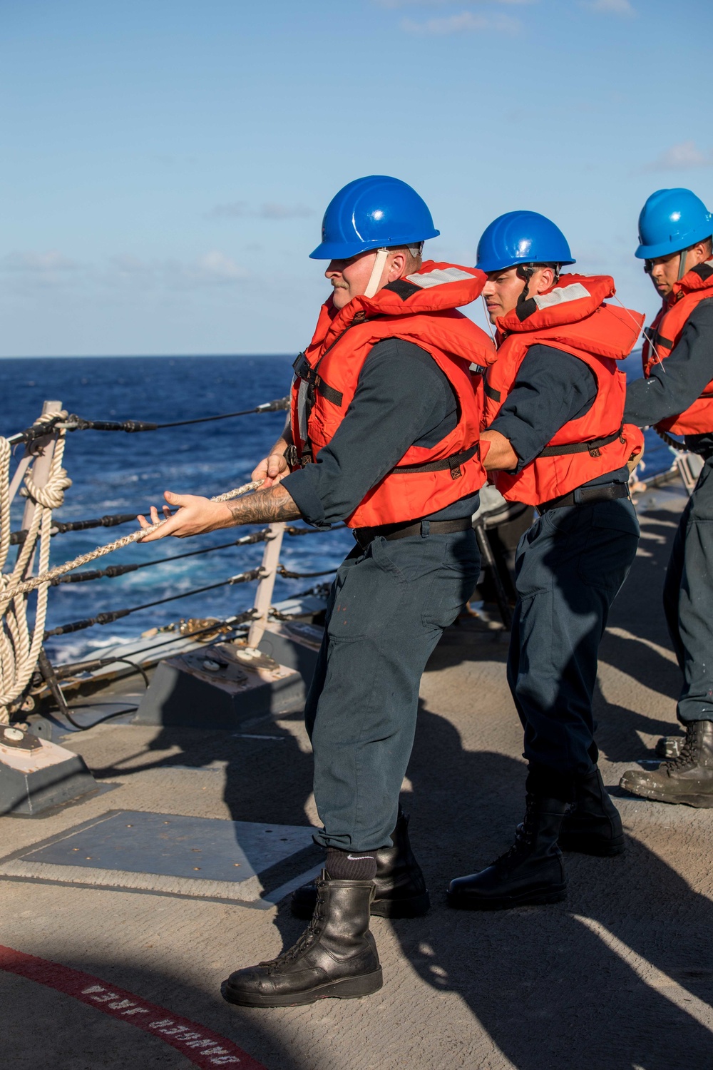 U.S. Navy Sailors heave line.