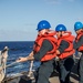 U.S. Navy Sailors heave line.