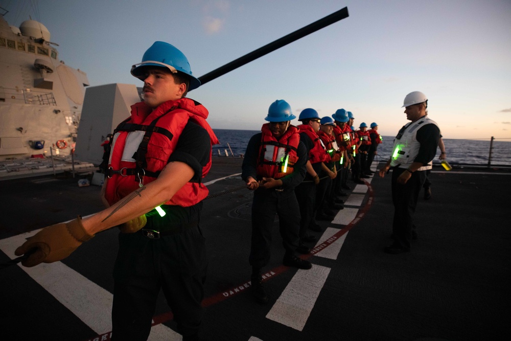 U.S. Navy Sailors handle the phone and distance line aboard USS Chung-Hoon