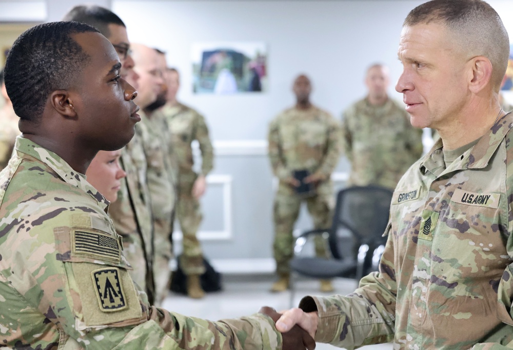 SMA Grinston gives coins to Soldiers while visiting Camp Arifjan, December, 2022