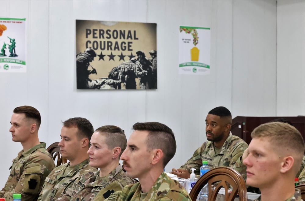 SMA Grinston gives coins to Soldiers while visiting Camp Arifjan, December, 2022