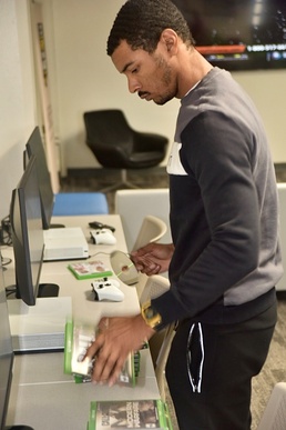 Spc. Collin Archer updates X-Box videogame software while off duty at the USO located in the D.C. National Guard Armory November 17, 2022.