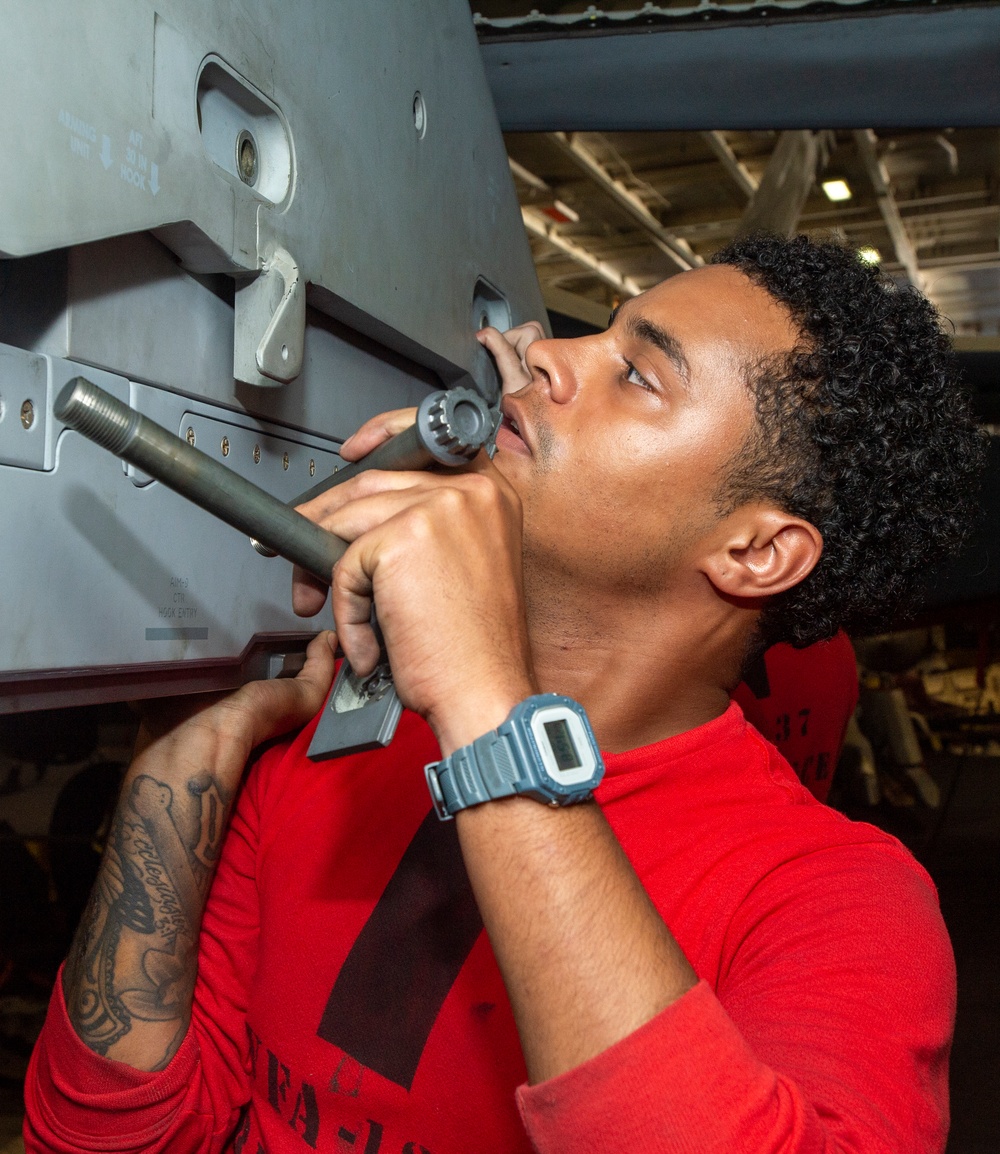 Sailor Installs Missile Launcher into Jet