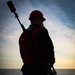 Sailor Stands By To Fire a Shot Line During a Replenishment at Sea Aboard CVN70