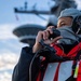 Sailor Uses a Sound Powered Telephone During a Replenishment at Sea Aboard CVN70