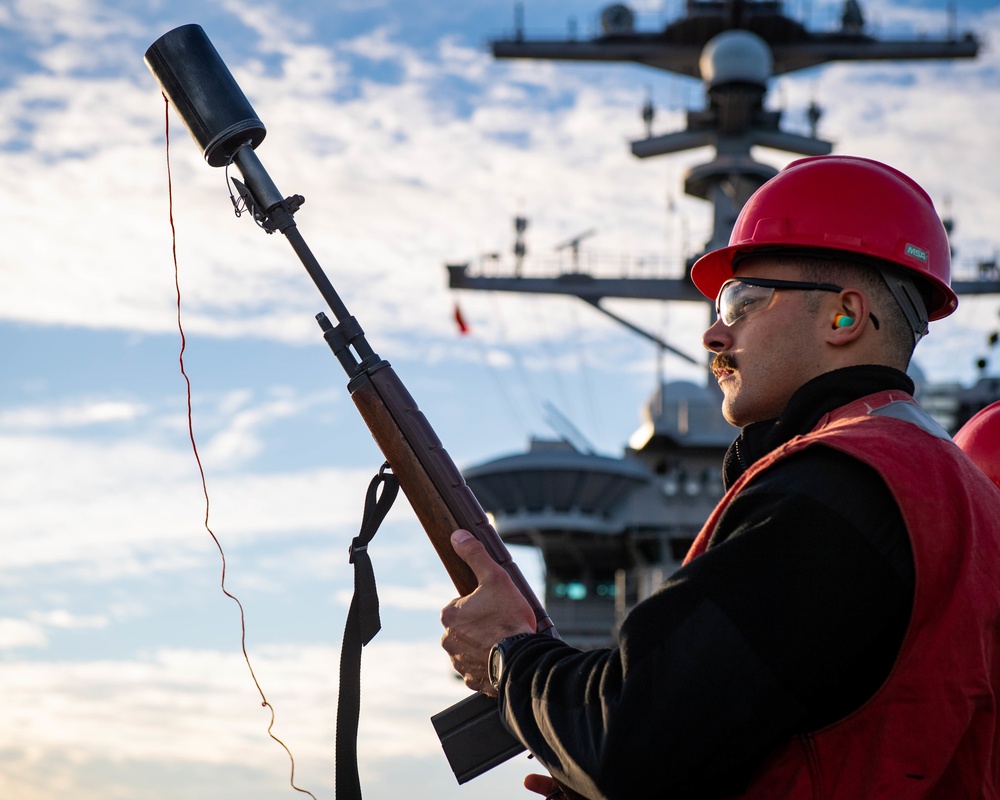 Sailor Prepares to Fire a Shot Line During a Replenishment at Sea Aboard CVN 70