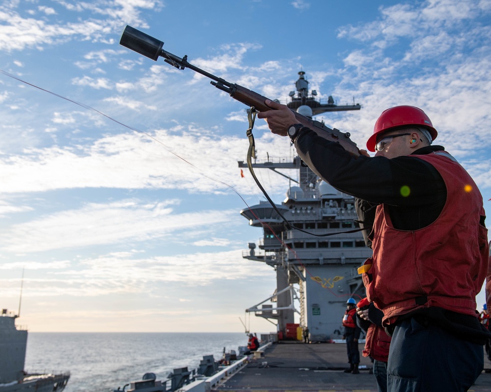 Sailor Prepares to Fire a Shot Line During a Replenishment at Sea Aboard CVN 70