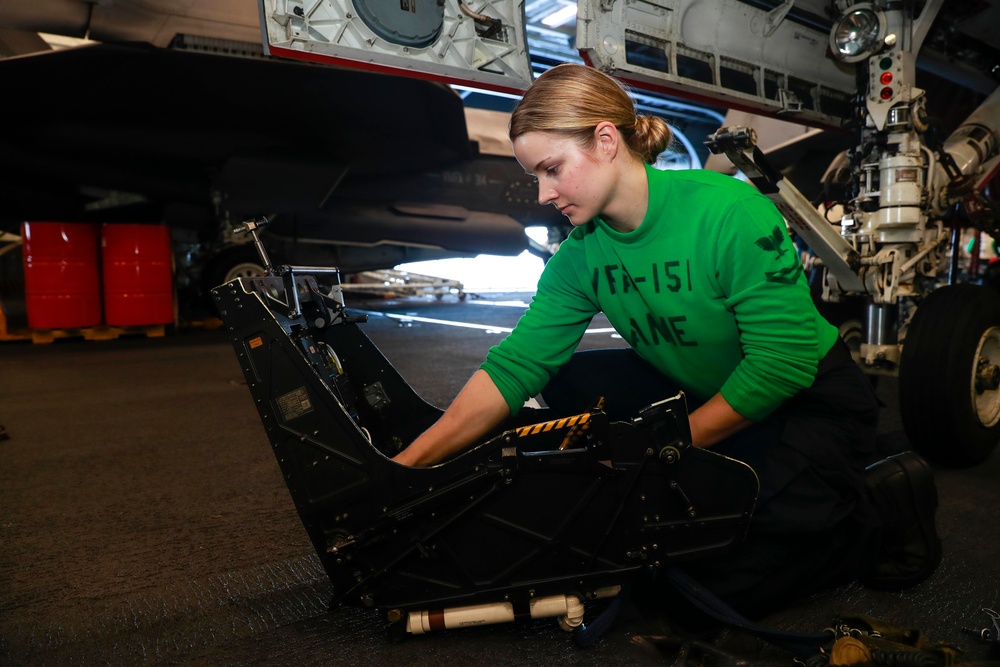 Abraham Lincoln Aviation Structural Mechanic (Safety Equipment) cleanses a seat bucket