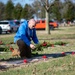 911th Security Forces Squadron squad leader, lays a wreath at a veteran’s gravesite at the Delaware Veterans Memorial Cemetery