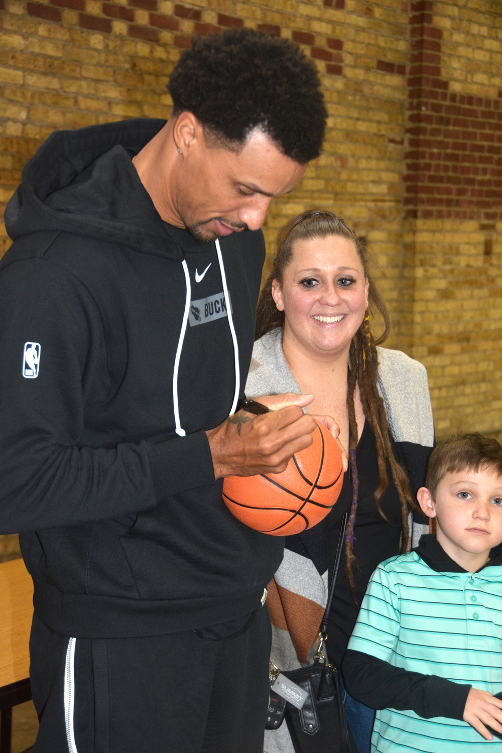 Milwaukee Buck scores winning play with families of deployed Wisconsin Guard members