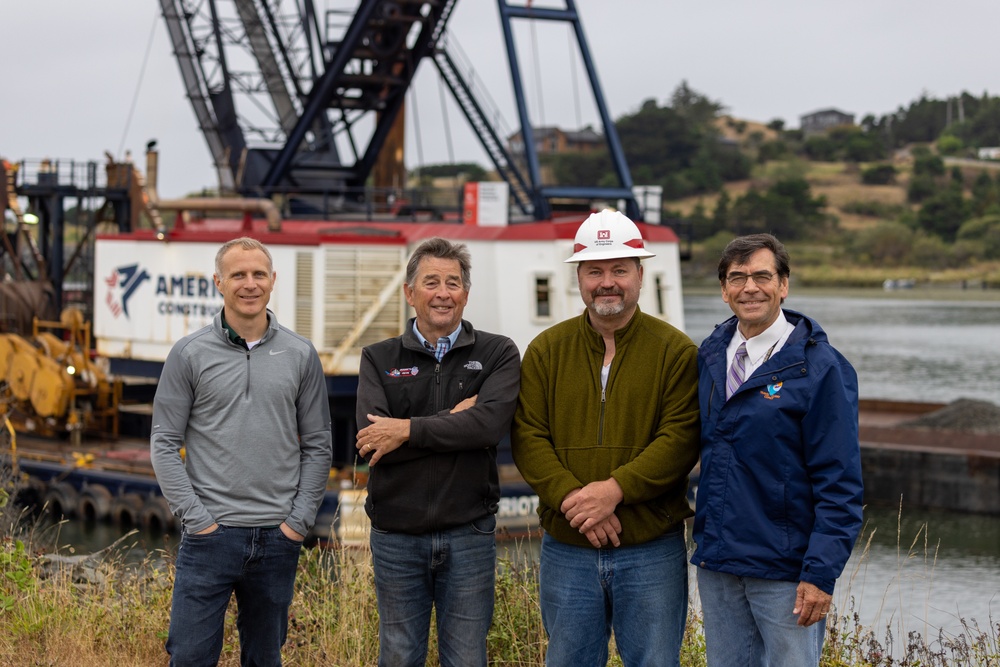 Local and Federal community members take a group photo to celebrate much needed dredging at the Mouth of the Rouge River, Ore.