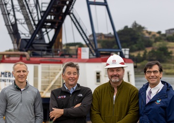 Local and Federal community members take a group photo to celebrate much needed dredging at the Mouth of the Rouge River, Ore.