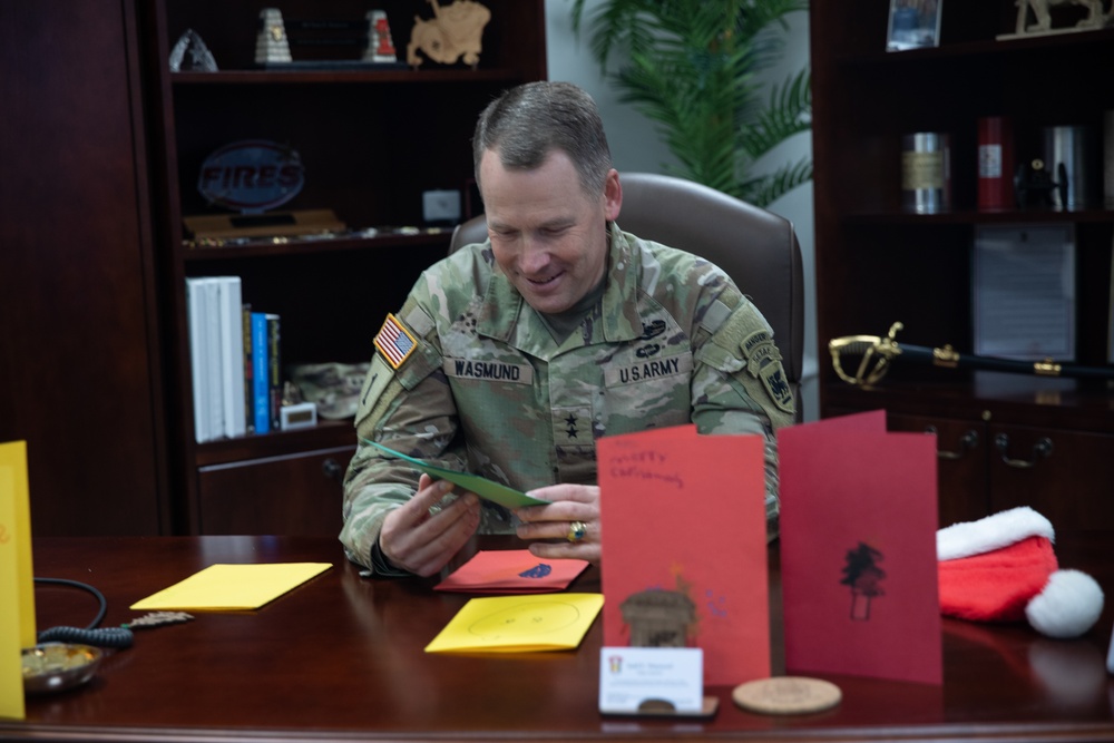 Maj. Gen. Todd R. Wasmund opens holiday cards from Centerville Ohio’s Primary Village North Elementary School