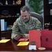 Maj. Gen. Todd R. Wasmund opens holiday cards from Centerville Ohio’s Primary Village North Elementary School