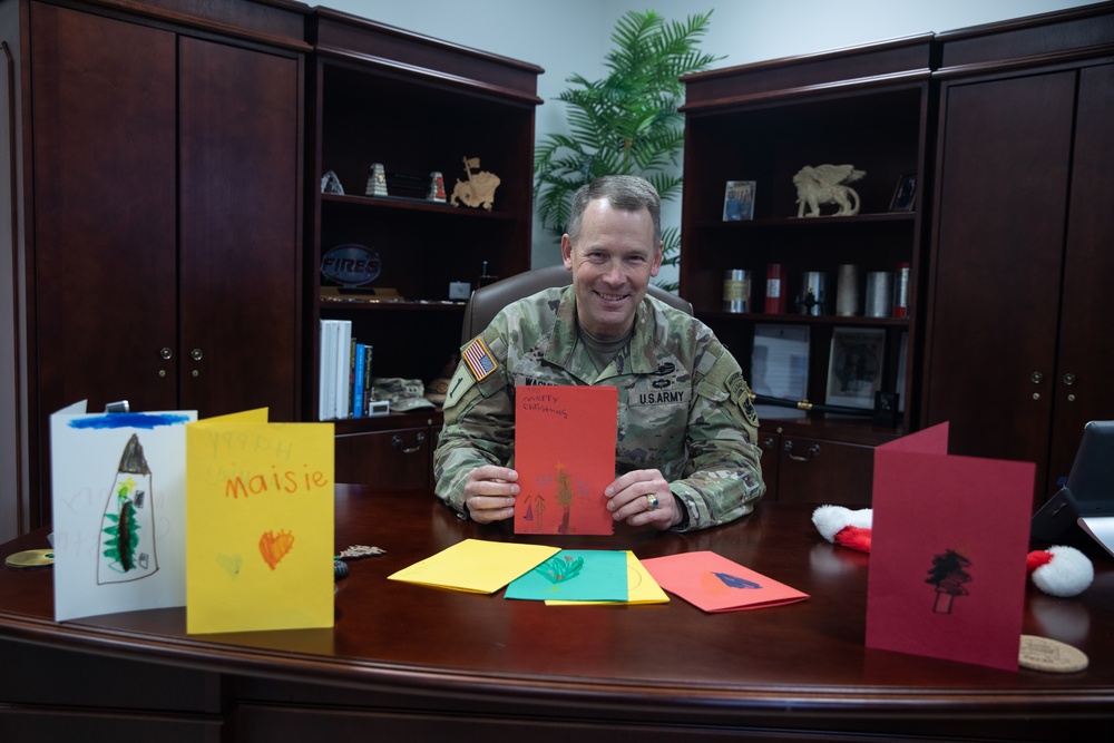 Maj. Gen. Todd R. Wasmund opens holiday cards from Centerville Ohio’s Primary Village North Elementary School