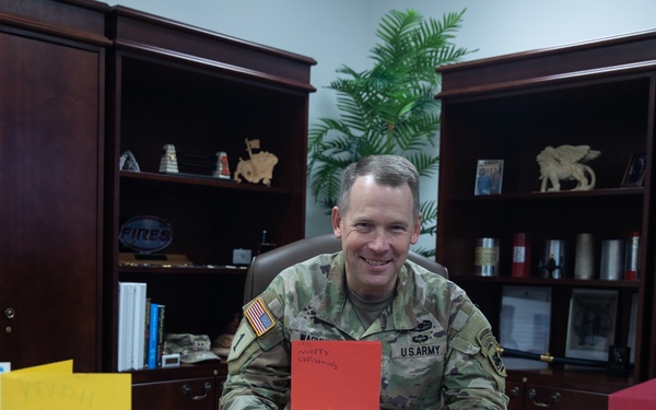 Maj. Gen. Todd R. Wasmund opens holiday cards from Centerville Ohio’s Primary Village North Elementary School