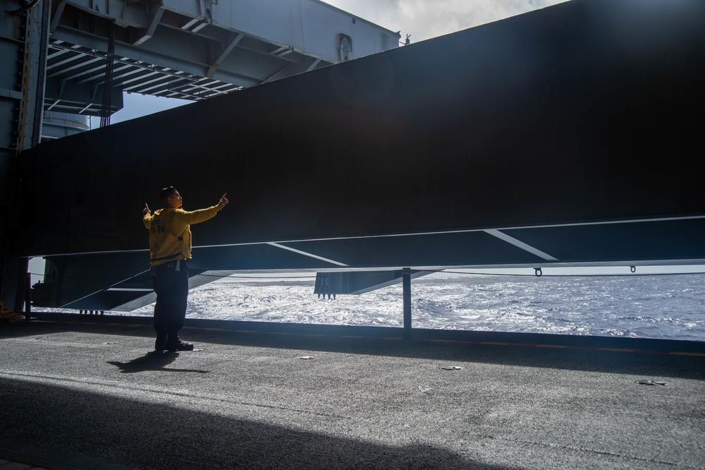 Sailor Directs Aircraft Elevator