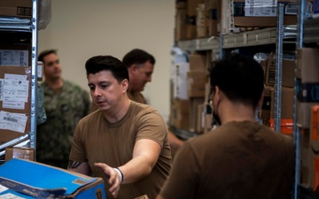 NSA Naples Community Lends a Hand to Deliver Influx of Holiday Packages