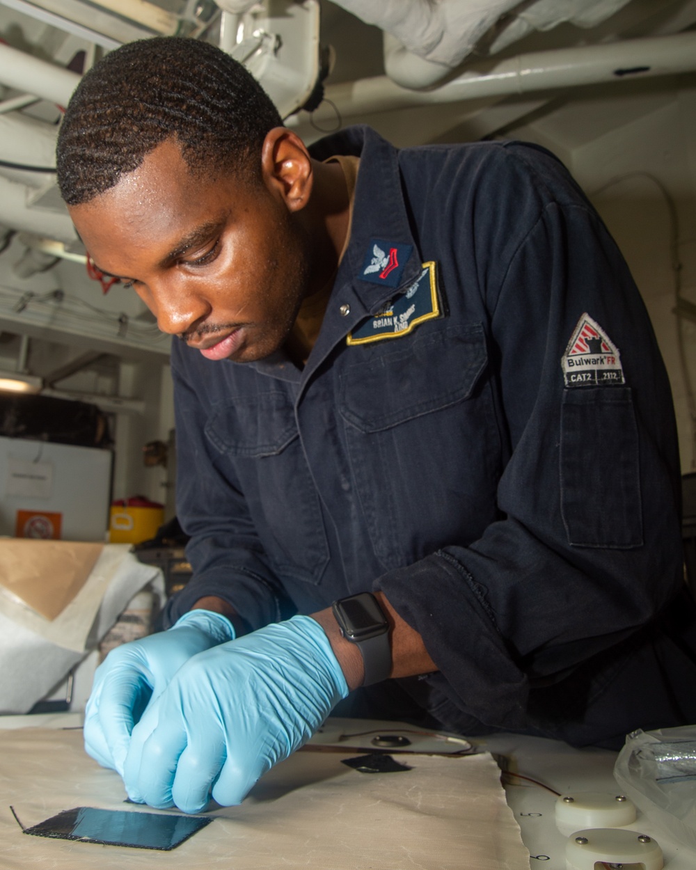 Sailor Lays Up Plies For Carbon Fiber Lamination