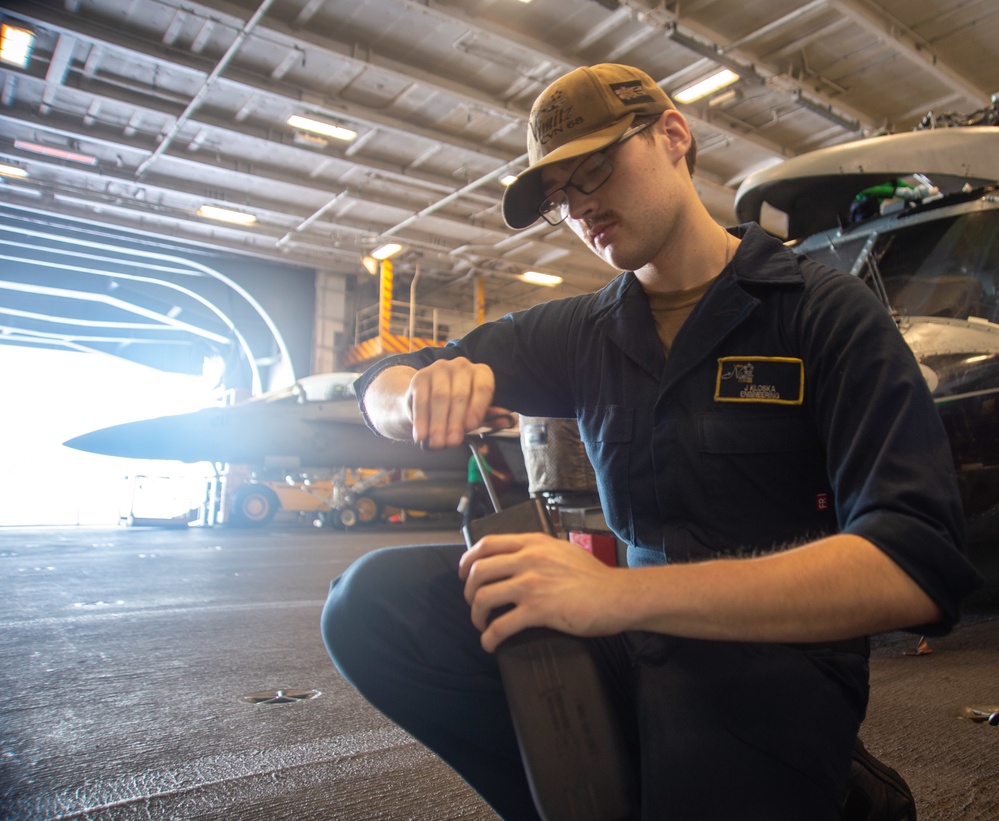 U.S. Navy Sailor Repairs Aircraft Auxiliary Equipment