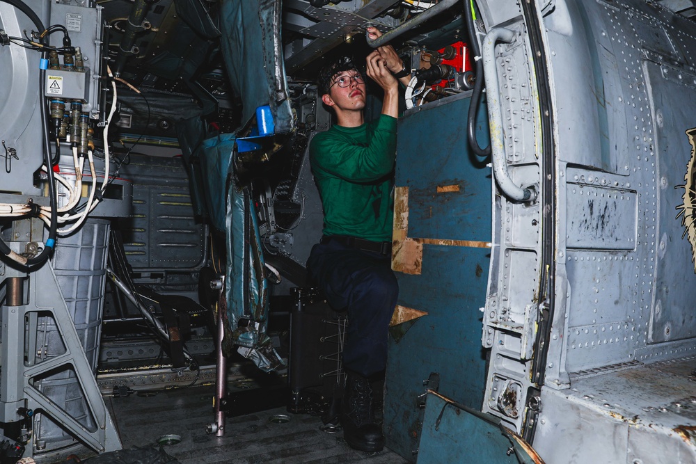 Sailor Performs Helicopter Maintenance