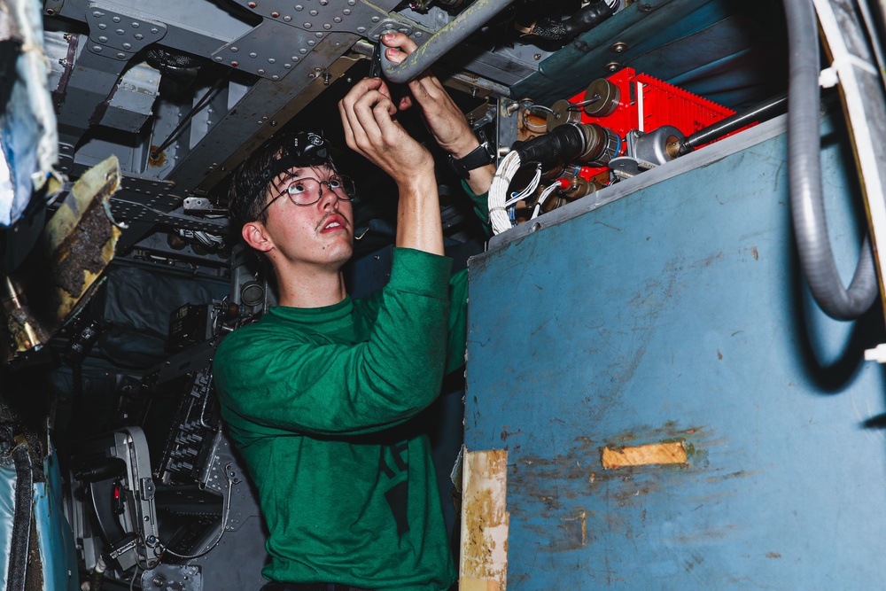 Sailor Performs Helicopter Maintenance